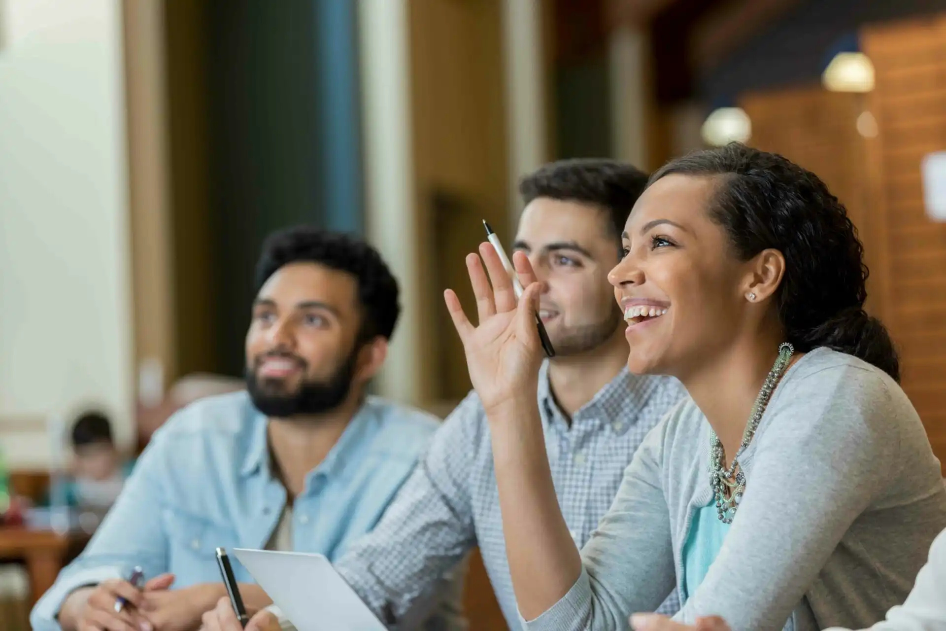 mid Adult Woman Raises Hand Duirng College Class